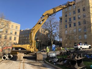 a crane blocks the loading dock while moving materials