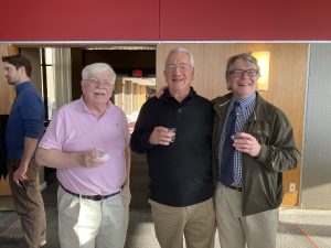 Tom Givnish, Ken Sebens and Mark Skinner stand together smiling at the camera