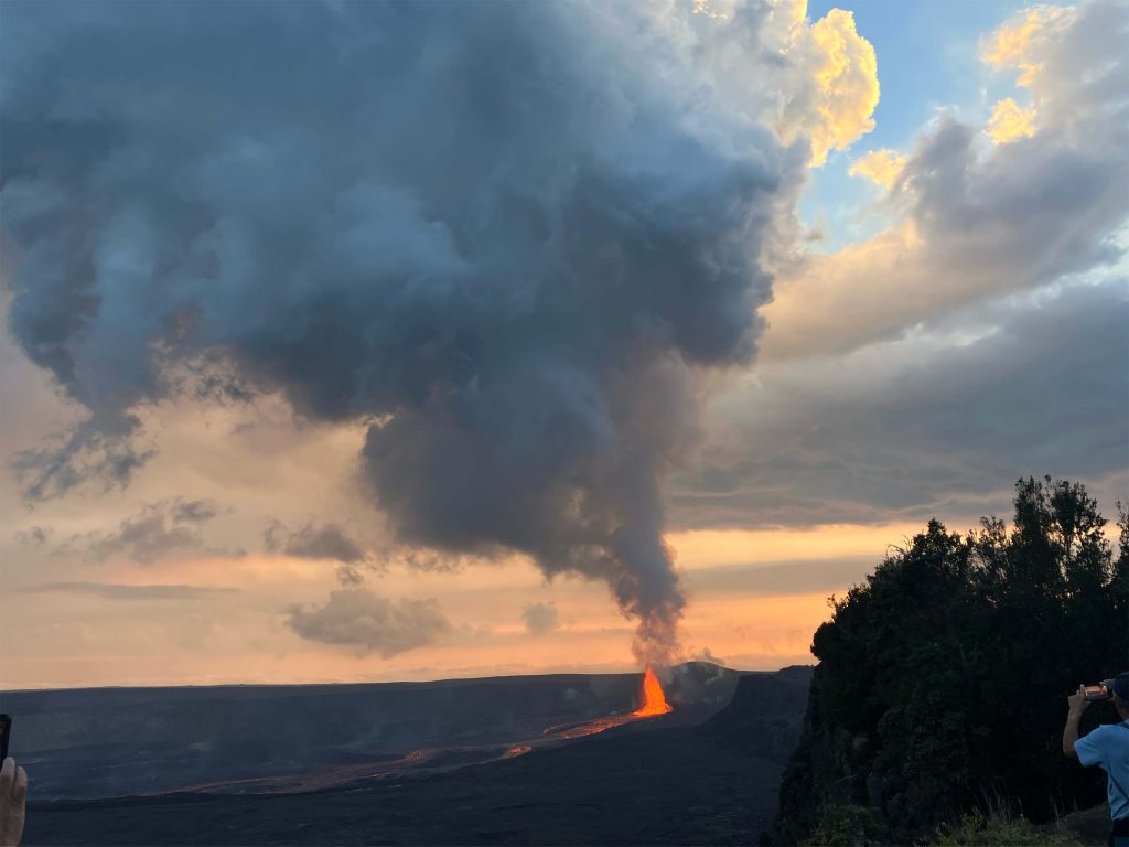 A plume of lava erupts from Kilauea as the sun sets